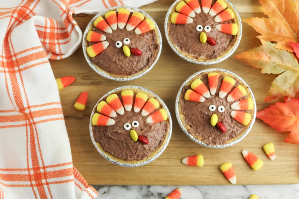 mini turkey pies made with chocolate pudding and decorated to look like turkeys