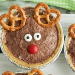 mini rudolph pies that are chocolate pudding pies decorated to look like rudolph