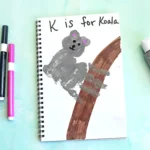 a Letter K Handprint Craft that is decorated to look like a koala with the words "K is for koala"