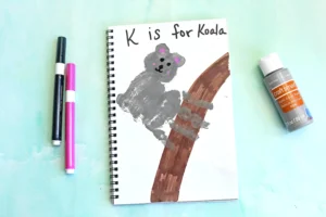 a Letter K Handprint Craft that is decorated to look like a koala with the words "K is for koala"