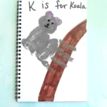 a Letter K Handprint Craft that is decorated to look like a koala with the words "K is for koala"