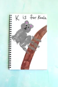 a Letter K Handprint Craft that is decorated to look like a koala with the words "K is for koala"
