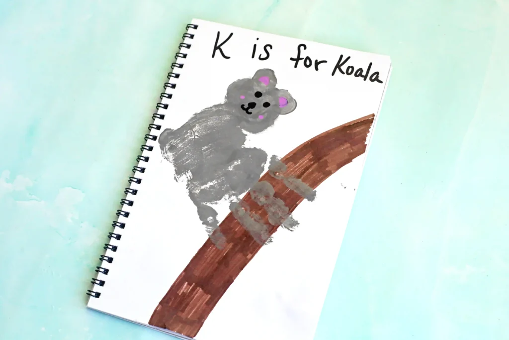 a Letter K Handprint Craft that is decorated to look like a koala with the words "K is for koala"