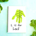 a letter L handprint craft that is a green handprint decorated to look like a leaf