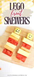 lego fruit skewers that look like lego people with watermelon, pineapple, and cantaloupe