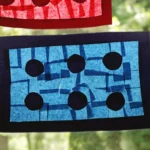 LEGO Brick Suncatcher made of tissue paper and contact paper hung in a window