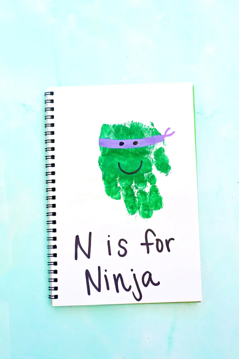 a letter n handprint craft that is a green handprint decorated to look like a ninja