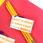back to school printable student gift tags that are pencils with a gift tag that reads "ready to write a great year" on a red and yellow background