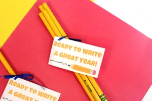back to school printable student gift tags that are pencils with a gift tag that reads "ready to write a great year" on a red and yellow background