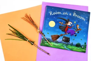 a broomstick nature craft that is a broomstick made out of pine needles, sticks, and twine to accompany the book "Room on the Broom"