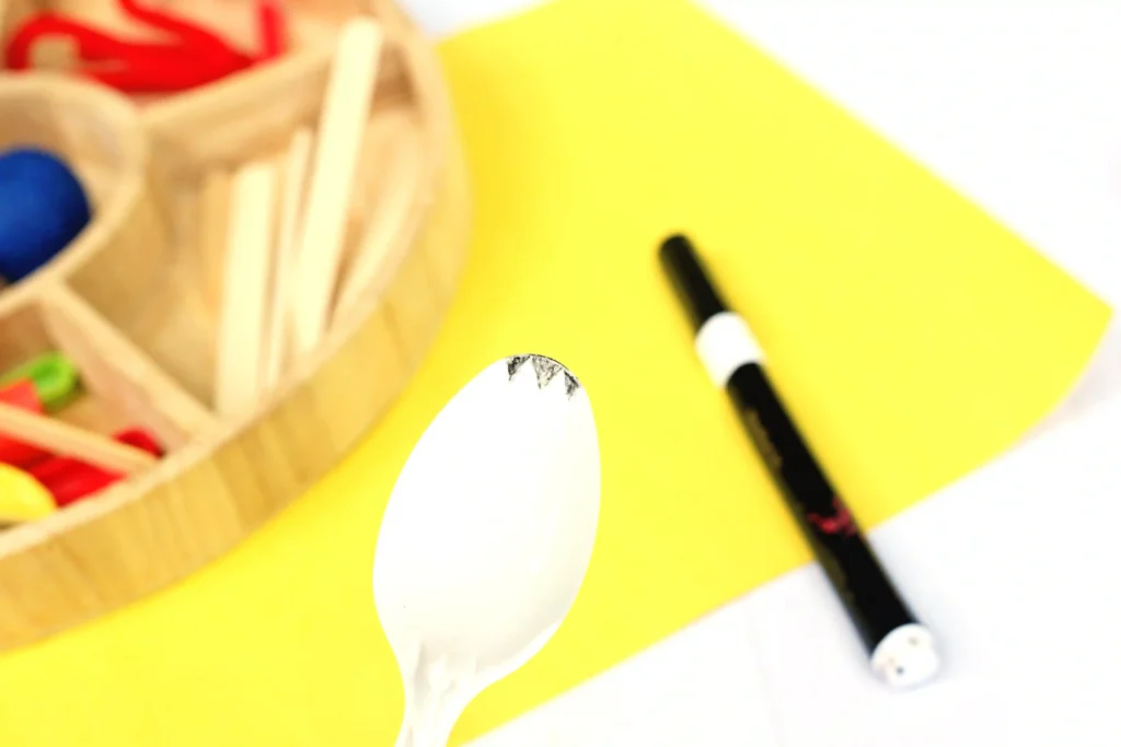 Toy Story Forky Playdough Tray - Cultivating Brilliant Minds a plastic spoon with black marks on top to make it look like a spork