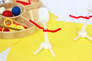 a plastic spoon with red pipe cleaner arms and craft stick feet to look like forky from toy story