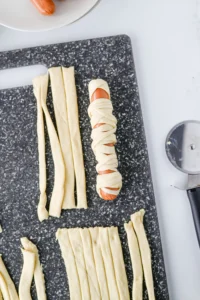 a hot dog wrapped with pastry dough to look like a mummy