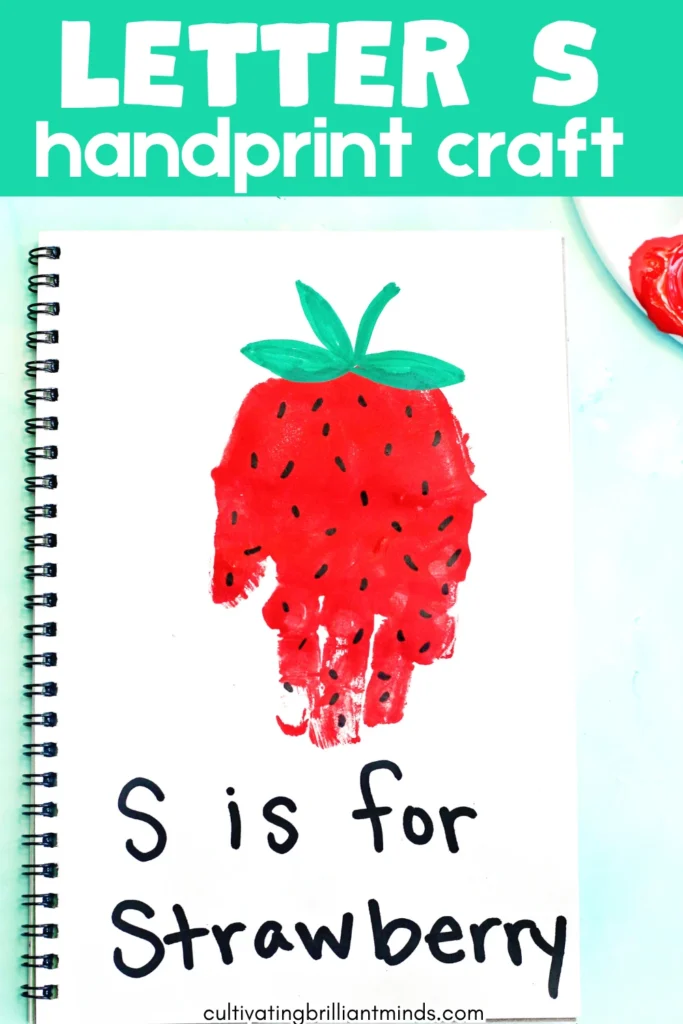 a red handprint decorated to look like a strawberry with the words "s is for strawberry"