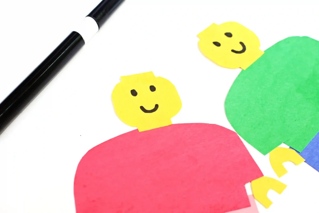 LEGO Minifigures - Cultivating Brilliant Minds a lego person made out of construction paper with a smiley face