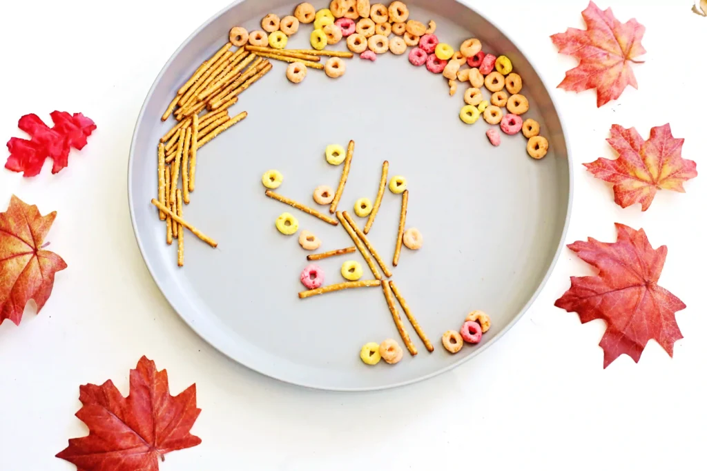 an Edible Fall Tree Craft made of pretzels and fruit loops