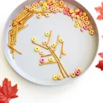 an Edible Fall Tree Craft made of pretzels and fruit loops