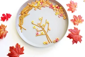 an Edible Fall Tree Craft made of pretzels and fruit loops