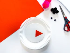a paper plate with an orange triangle glued on