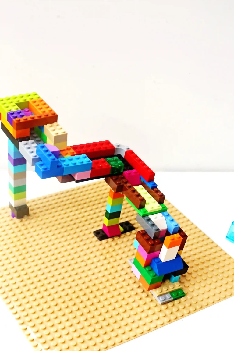 Colorful LEGO brick structure built on a tan baseplate against a white background.