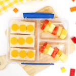 a LEGO-themed Lunchbox Idea that has sandwiches that look like legos and stacks of fruit