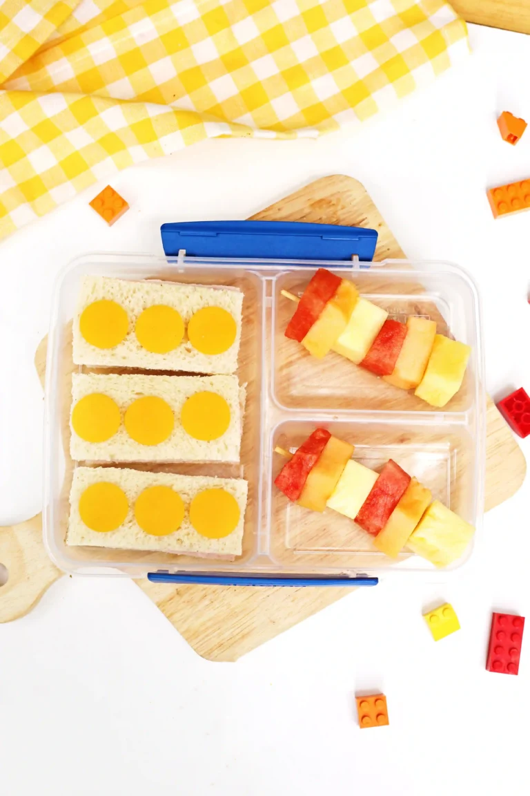 a LEGO-themed Lunchbox Idea that has sandwiches that look like legos and stacks of fruit