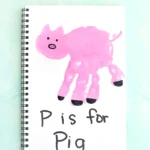 a letter p handprint craft of a pink handprint decorated to look like a pig