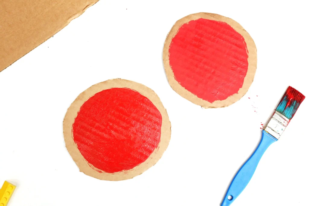 round pieces of cardboard painted red