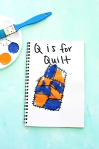 a letter q handprint craft that is designed to look like a quilt with "Q is for quilt"