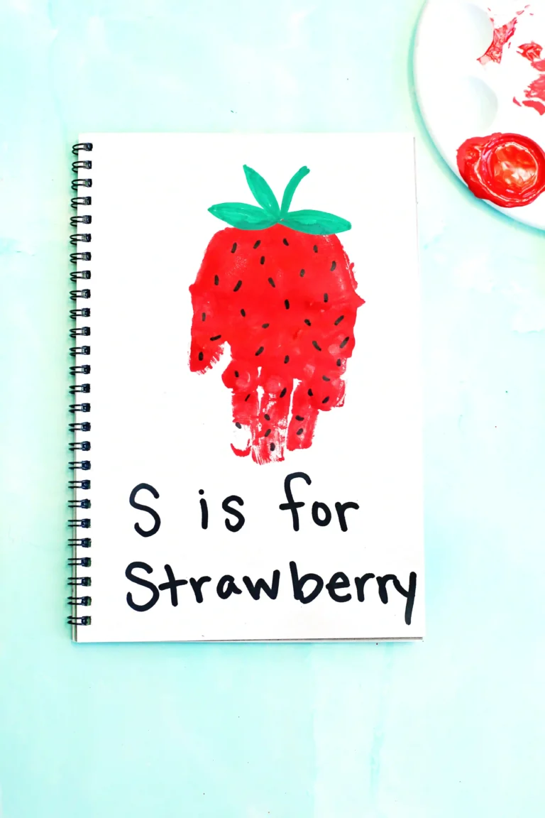 a red handprint decorated to look like a strawberry with the words "s is for strawberry"