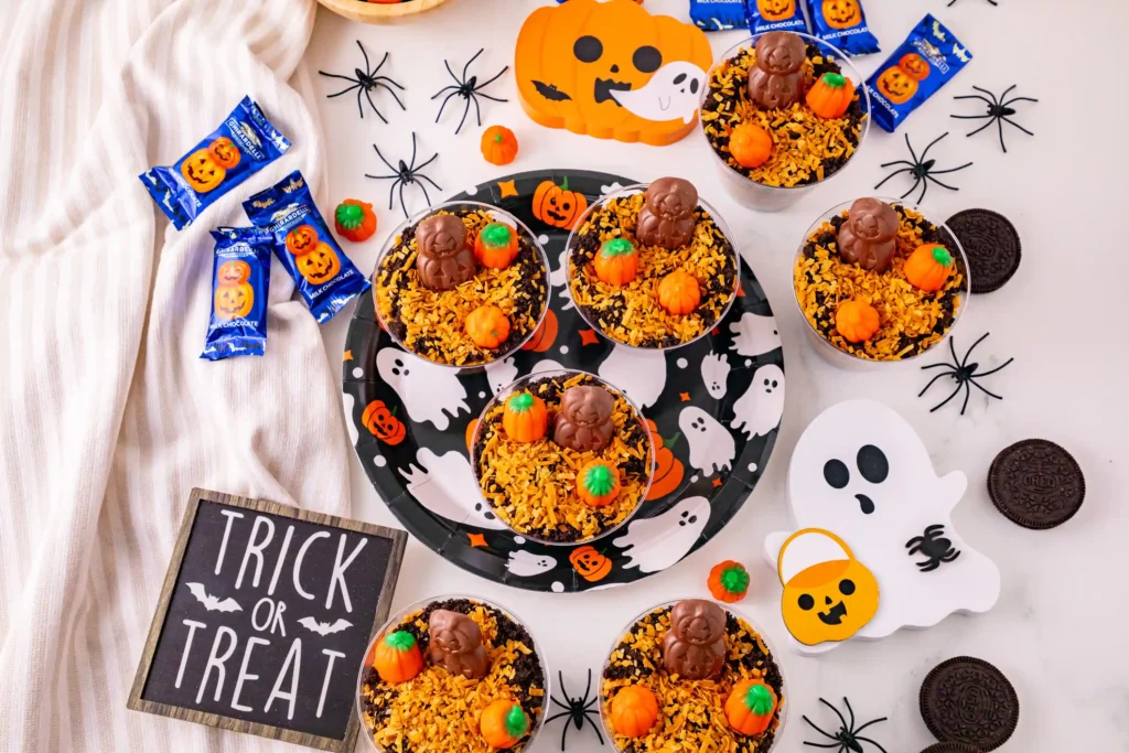Pumpkin Patch Dirt Cups that have a chocolate pumpkin and candy pumpkins on top