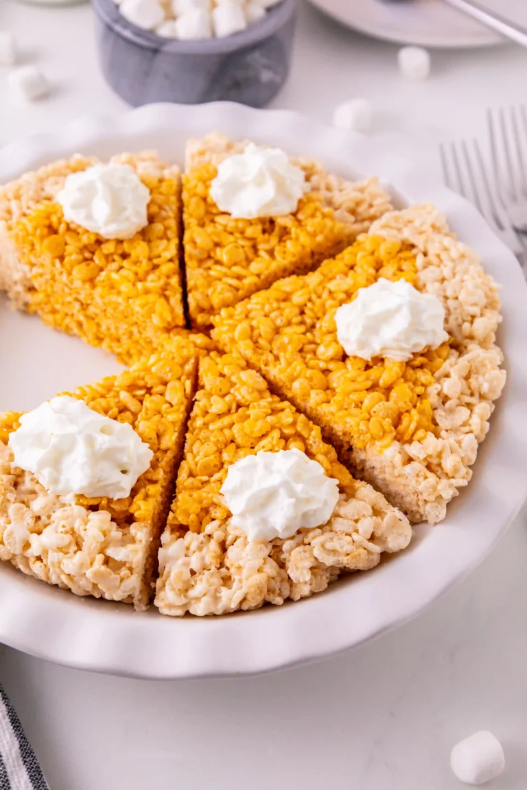 rice krispie treats made into a pumpkin pie with whipped cream on top