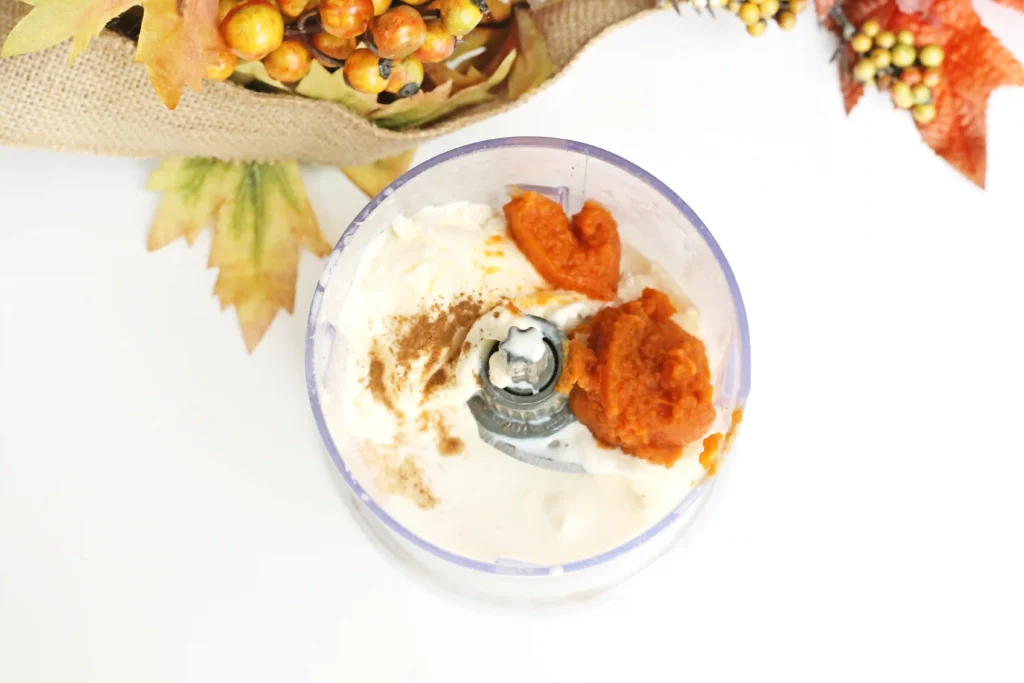 vanilla ice cream, milk, pumpkin puree, pumpkin pie spice, and vanilla extract in a blender.