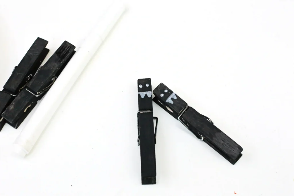 Bat Snack Bags - Cultivating Brilliant Minds Close-up of black binder clips with white face drawings on a white surface.