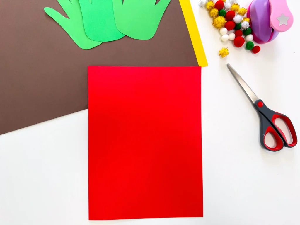 red construction paper folded in half to make a card