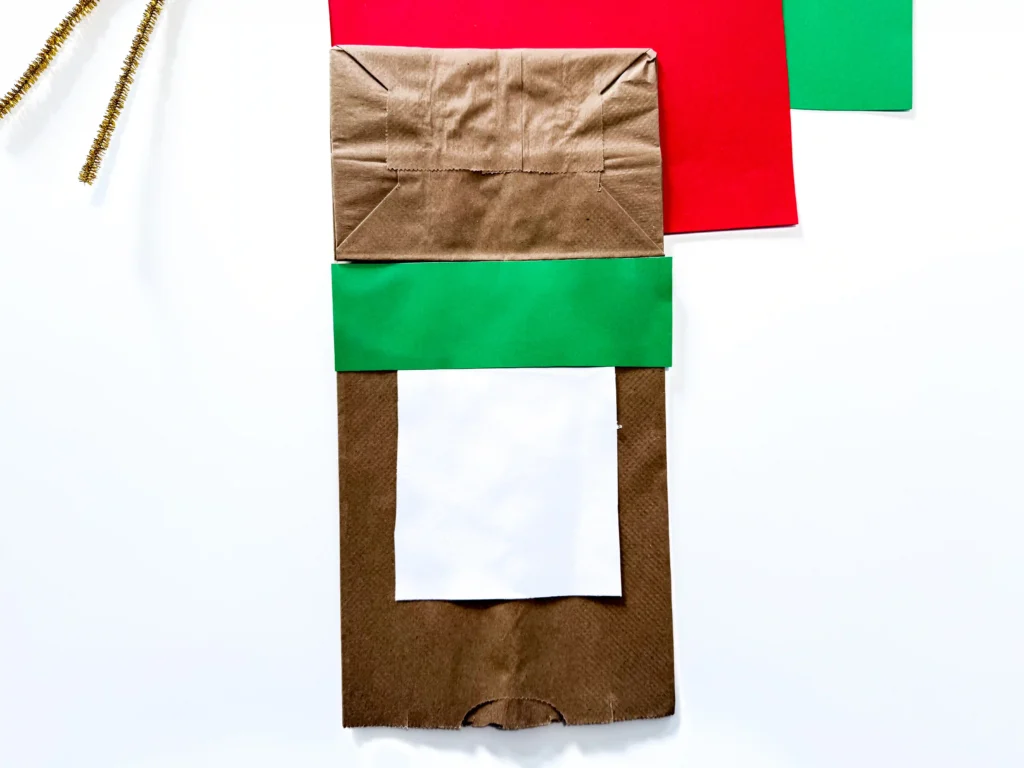 a brown paper bag with a green stripe across it.