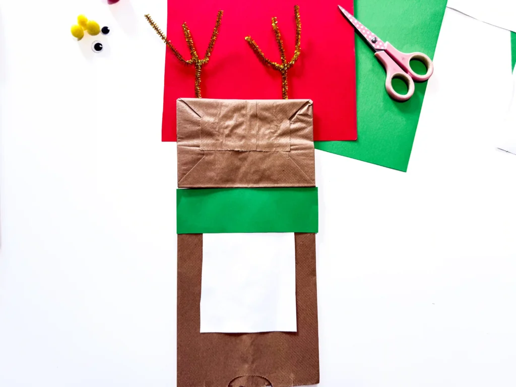 a brown paper bag decorated to look like a reindeer