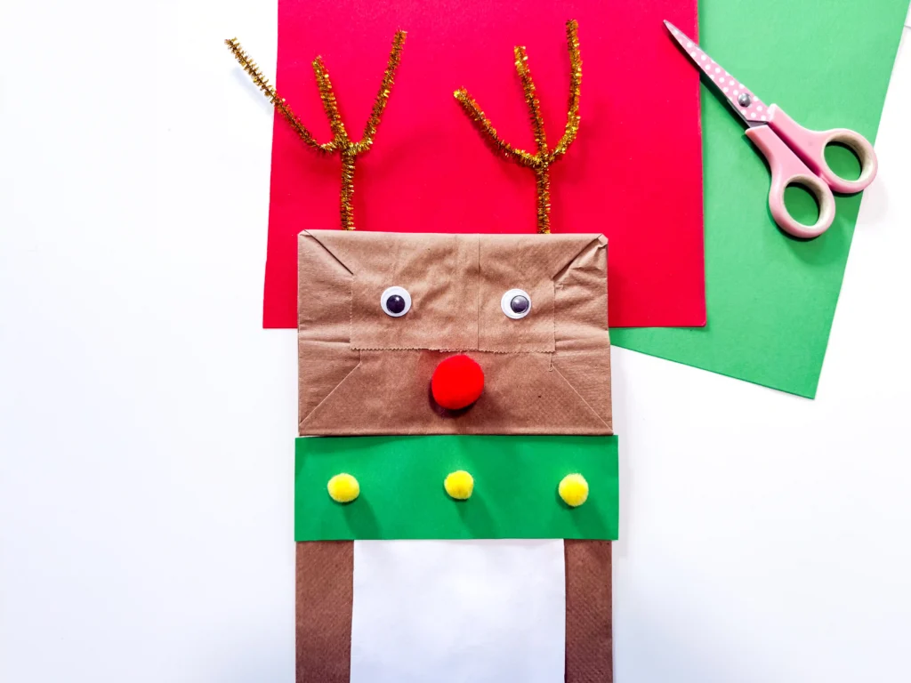 a brown paper bag decorated to look like a reindeer