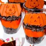 Halloween Dirt cups with crushed oreos, orange dyed pudding, and little debbie pumpkin brownies