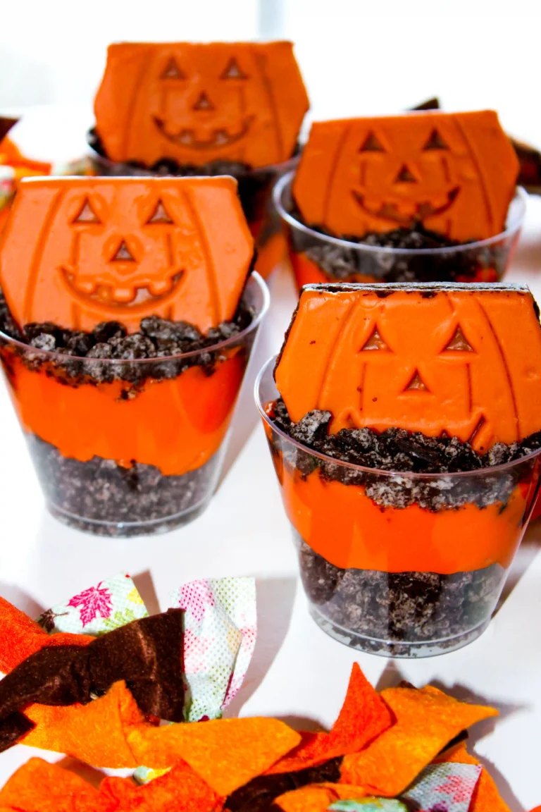 Halloween Dirt cups with crushed oreos, orange dyed pudding, and little debbie pumpkin brownies