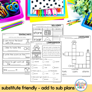 Bright classroom worksheets for early literacy (sentence match, comprehension, crossword, new words) with colorful supplies like pencils, scissors, and folders nearby.