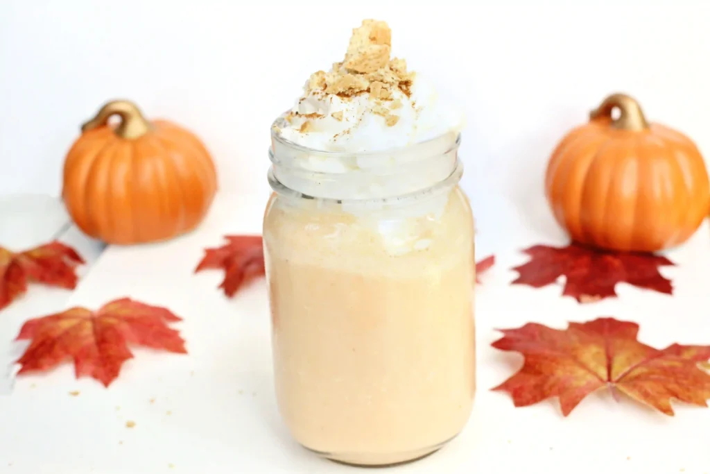 a Pumpkin Pie Milkshake in a mason jar topped with crushed graham crackers