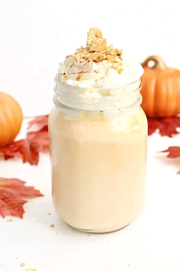 a Pumpkin Pie Milkshake in a mason jar topped with crushed graham crackers