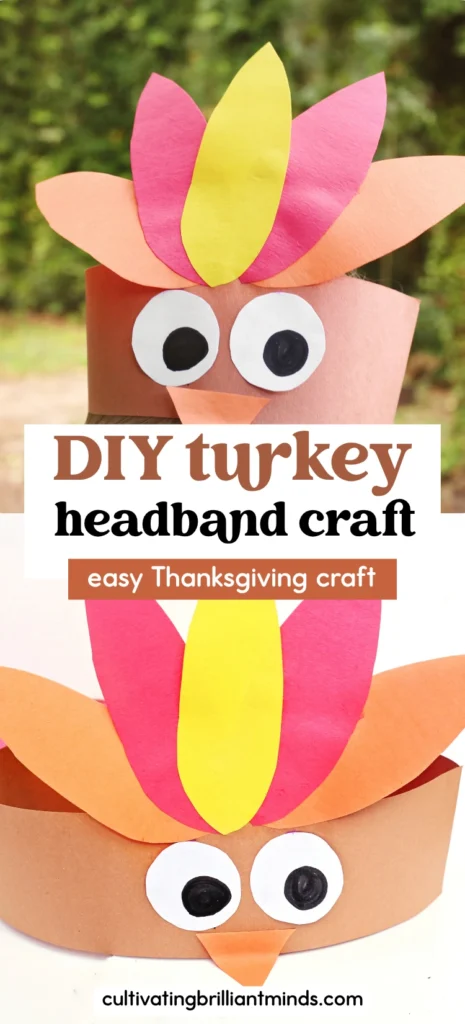 Paper craft turkey with a brown body, white and black eyes, an orange beak, and bright colored feathers in pink, yellow, and orange.