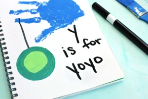 a blue handprint with a yoyo and words that read "y is for yo yo"