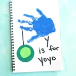 a blue handprint with a yoyo and words that read "y is for yo yo"