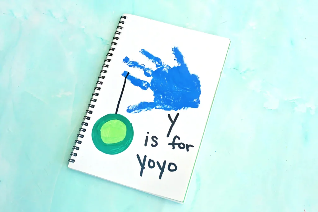 a blue handprint with a yoyo and words that read "y is for yo yo"