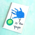 a blue handprint with a yoyo and words that read "y is for yo yo"