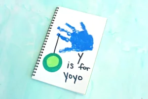 a blue handprint with a yoyo and words that read "y is for yo yo"