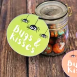 a jar with toys spiders and candy with a tag that says bugs and kisses